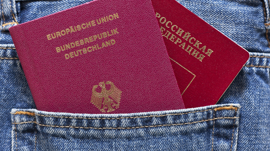 A German and a Russian passport in a trouser pocket