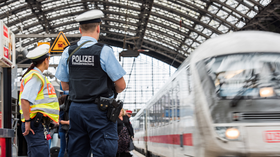 Two police officers patrolling a station